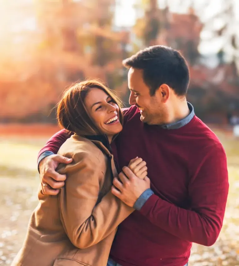 Senior couple walking hand in hand on a gravel path